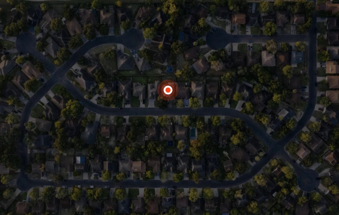An aerial view of a neighborhood with a target radius drawn around one home